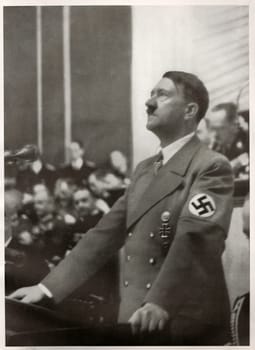 Hitler speaks to the Reichstag on the Jewish Question. Reproduction of antique photo.