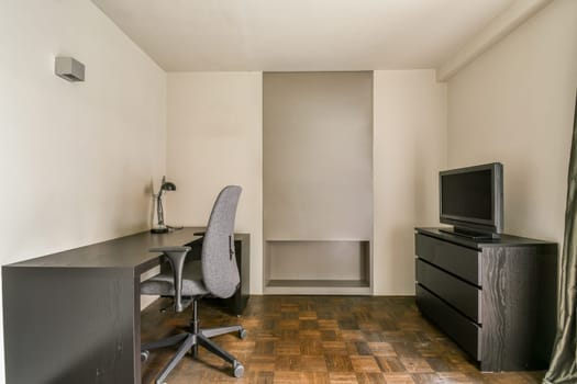 an office space with a desk and a tv