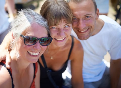 Enjoying the festival vibe. Portrait of three adults at an outdoor festival.