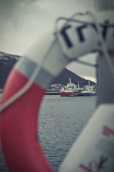 Lifebelt in the harbour of Tromso, Norway. Ship in the background.