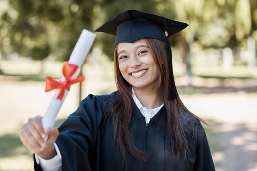 University, graduation and portrait of girl with diploma on campus smile for success, award and achievement. Education, college and happy female graduate with certificate, degree and academy scroll