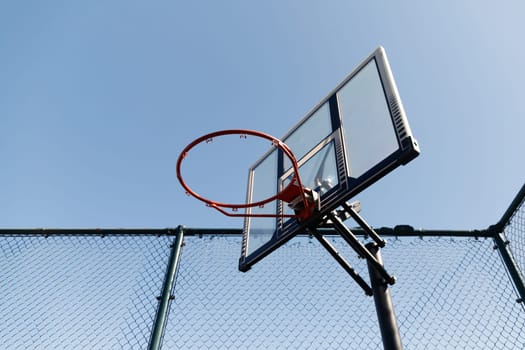 Streetball basket outdoor. Blue sky as background and copy space. Urban youth game