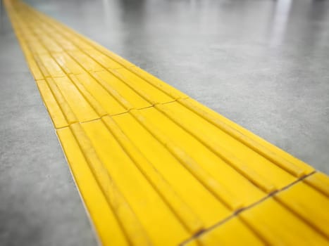 Walkway or yellow tactile tiles for the blind in the urban environment