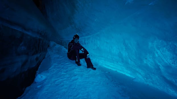 The climber made a halt inside an ice cave.