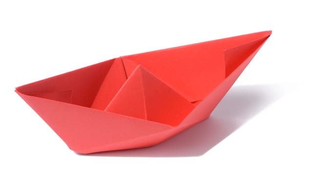 Red paper boat on a white isolated background