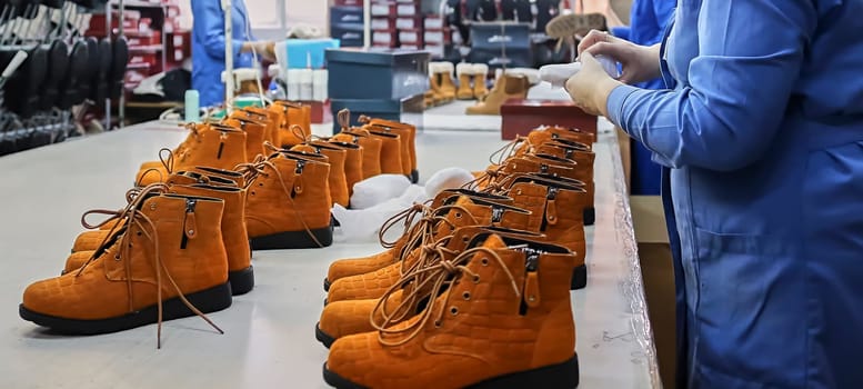 Checking the quality of shoes in a shoe factory.