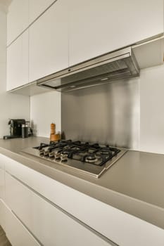 a kitchen with white cabinets and a stove top