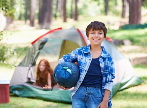 Claiming his camping spot. A boy standing in front of his campsite.