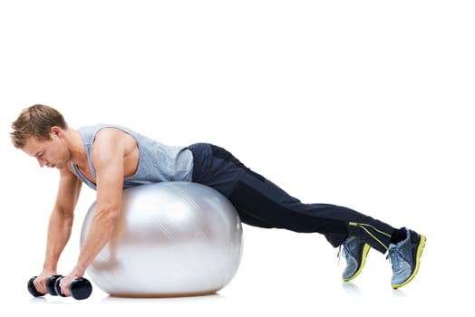 Gym equipment made useful. a man balancing on an exercise ball holding weights.