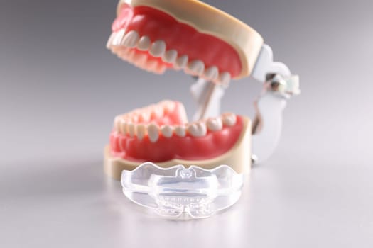 Silicone orthodontic retainers to hold teeth and artificial jaw