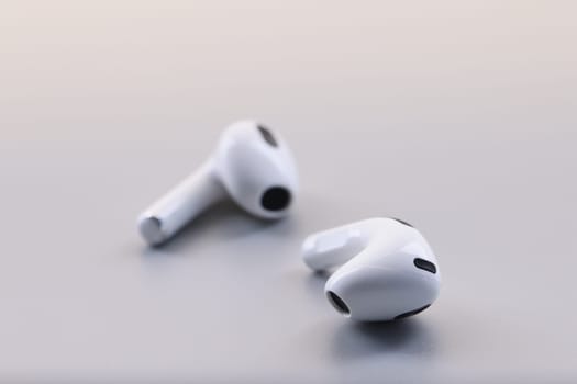 Wireless white stylish bluetooth headphones on gray background