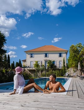couple men and women in swimming pool of luxury vacation home in the Ardeche France Europe