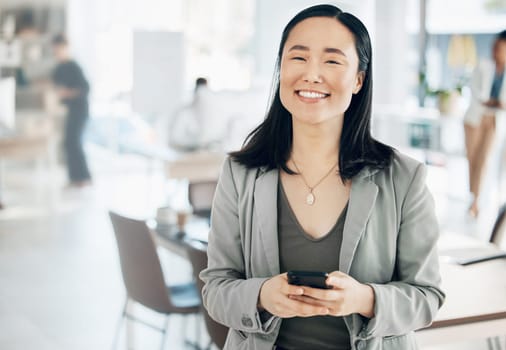 Portrait, success and Asian woman in office, smartphone and typing for social media, happiness and connection. Face, Japanese female employee and manager in workplace, cellphone and communication.