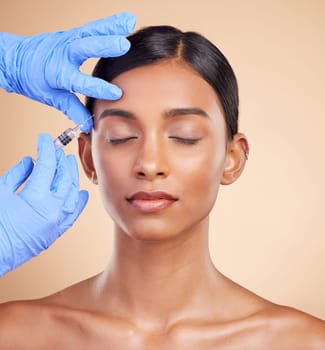 Studio, face lift or Indian woman with injection for beauty, plastic surgery or medical cosmetics. Skincare, dermatology or hands with needle in filler facial treatment on young girl with eyes closed