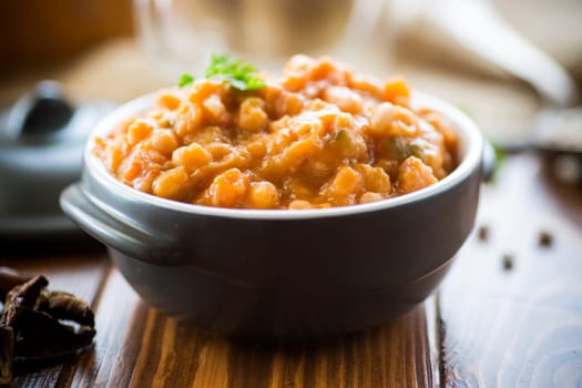 beans stewed with vegetables and spices, in a bowl .