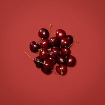 Cherry picking the best ones. a bunch of cherries against a studio background.