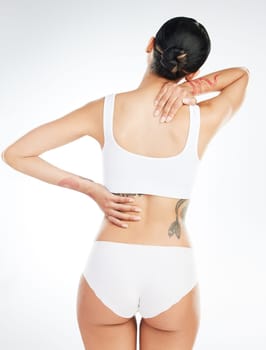 Someday this pain will be useful to you. Studio shot of an unrecognizable woman experiencing back pain after working out against a white background.