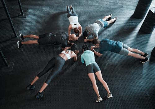 Dont forget your breathing. a group of friends planking together.