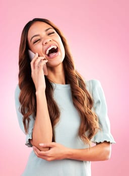 Woman, phone call and laugh with communication and technology, funny conversation on pink background. Happiness, young female with smile and connection with network, talking on mobile in studio.