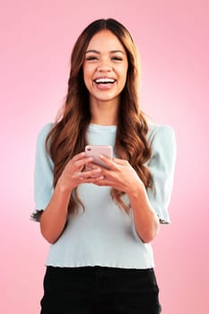 Phone, portrait and happy woman in studio online for communication, social media or app on pink background. Face, smartphone and girl smile for streaming, subscription or internet comic isolated