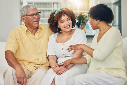 Family, woman and home with senior people talking on a living room sofa in a house. Smile, communication and love of a female with elderly parents conversation in a lounge together on a couch.