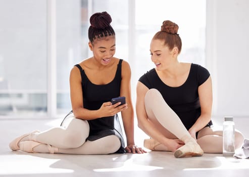 Take some videos today. a ballet dancer showing her friend her smartphone.