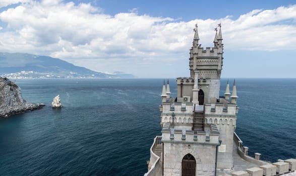 Crimea Swallow's Nest Castle on the rock over the Black Sea. It is a tourist attraction of Crimea. Amazing aerial view of the Crimea coast with the castle above abyss on sunny day.