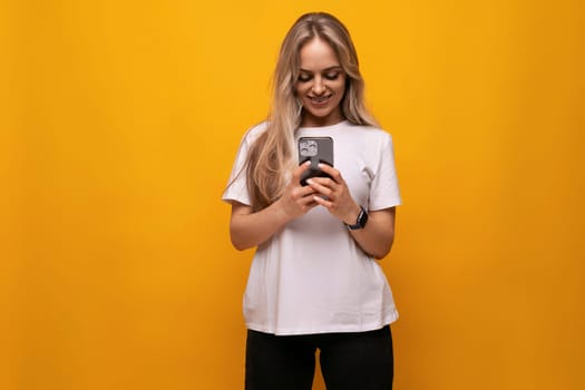 consultant girl with a phone in her hands on a yellow background