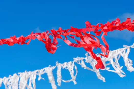Decorative vivid red and white ribbons prepared for a religious festival