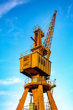 Obsolete yellow crane on the harbor