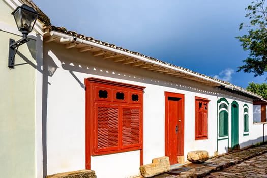 Street with ancient colonial style houses with colorful doors and windows