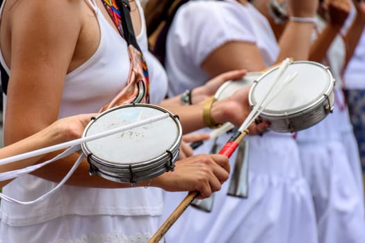 Women playing tambourine in the streets of Brazil