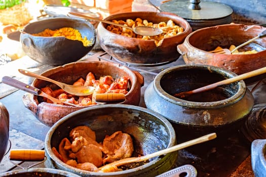 Traditional Brazilian food being prepared in clay pots