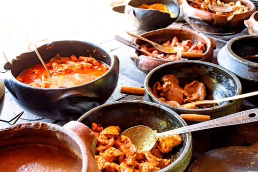 Traditional Brazilian food being prepared in clay pots