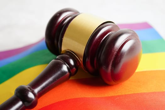 Gavel for judge lawyer with heart rainbow flag, symbol of LGBT pride month.