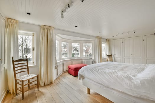 the master bedroom has a large bed and a window