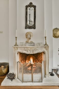 a fireplace with a marble mantel and a statue