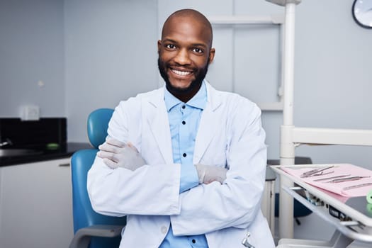 Have a dental health concern Come see me. Portrait of a confident young man working in a dentists office.