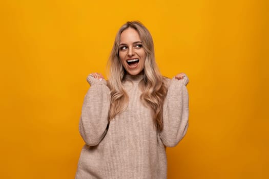 photo of a girl happily waving hand on a yellow background