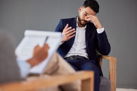Sad man consulting therapist in therapy or counseling for mental health, depression or stress help, advice and support. Checklist, evaluation and psychologist with business person or patient talking