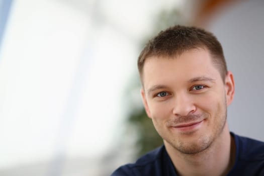 Portrait of handsome smiling young man with stubble