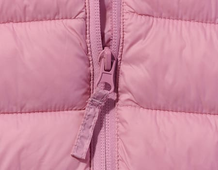 Fragment of a pink jacket with a zipper
