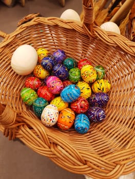 Easter wooden eggs in a basket close-up