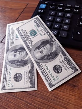 Money dollars and calculator on desktop