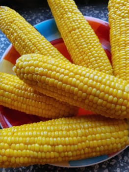 Boiled juicy corn on a plate