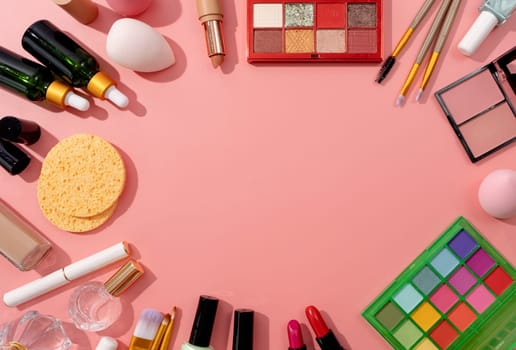 Bright summer eyeshadow palette and makeup products on pink background, vivid summer flatlay