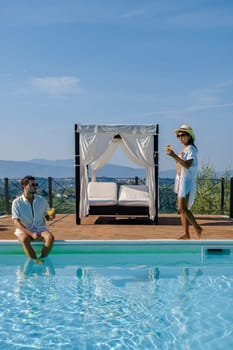 Couple on vacation Luxury country house swimming pool in Italy. Pool and old farm house at sunset