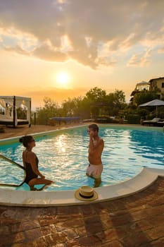 Couple on vacation Luxury country house swimming pool in Italy. Pool and old farm house at sunset