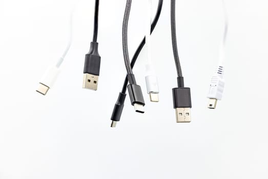 Various USB cables and plugs isolated against white