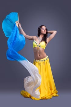Beauty dancer in yellow costume dance with fantail